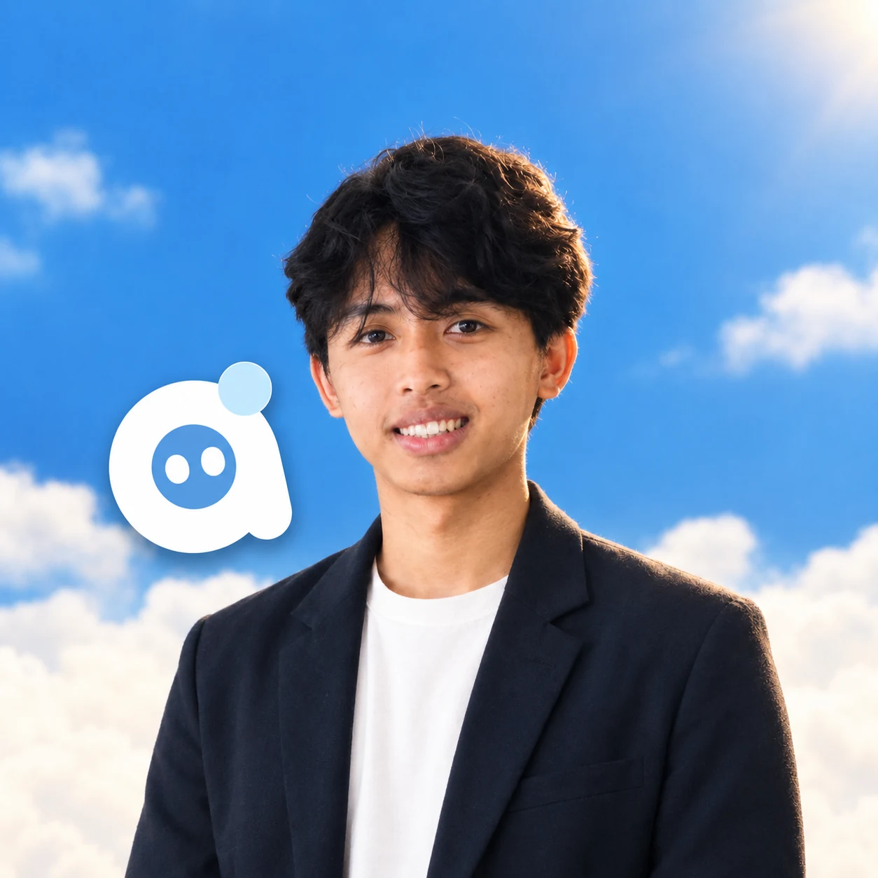 Andika Dwi Saputra smiling against a blue sky with clouds, wearing a navy blazer over a white T-shirt, next to Tejo the mascot